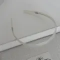 Close-up detail of a minimalist transparent resin headband featuring subtle teeth for secure grip. - Mermaid White Acetate Headband