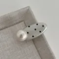 Close up detail view of the sweet style polka dot hair clip featuring a large pearl accent. - Oval Pearl Clip / Off White