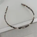 Tortoiseshell thin hair hoop with teeth, glossy acetate finish, close-up detail view. - Milk Coffee Acetate Headband