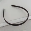 Close-up view of a dark brown anti-slip toothed headband detail showing clean texture. - Reddish Brown Acetate Headband