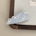 Close-up detail of the elegant pearl bow hair clip, showcasing delicate beaded bow design. - Blue Pearl Bowknot Hair Clip / Blue