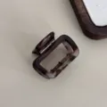 Detailed view of a chic dark tortoise shell rectangular hair claw clip for elegant styling. - Small Square / 5cm / Gray Leopard