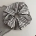 Close-up detail of striped fabric hair scrunchie with handmade tag on clean white table. - Korean Scrunchie - Black White Stripe