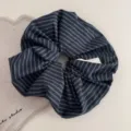 Detail view of the black and blue striped fabric scrunchie, showcasing textured retro hair tie. - Korean Scrunchie - Blue Black Stripe