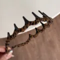 Leopard print wavy hair hoop with teeth, detail view of handmade wrapped hair accessory. - Headband / Dark Leopard Print