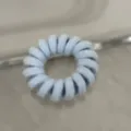 Close-up detail of a light blue fabric wrapped telephone wire hair tie, simple and elastic. - Candy Color Telephone Cord-Light Blue