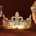 Detailed shot of the exquisite metal engravings and sparkling crystal rhinestones on the crown. - Gold