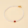 Elegant vintage pearl choker necklace featuring a sparkling red gemstone and gold toggle clasp. - Red Gem Necklace (AMY696R)