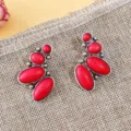 Detailed shot of vintage bohemian red stone drop earrings with silver metal geometric frame. - Multi-Step Oval Red Stone Style (A23-813R)