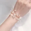 Detail view of bridal pearl wrist corsage, delicate wire vine design with frosted beads for events. - Crystal White (005)