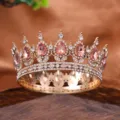 Close-up detail of a vintage gold full-circle tiara crown sparkling with pink and clear rhinestones. - Champagne