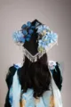 Decorated graduation cap with blue artificial flowers, butterflies and pearl fringe. - Main Image Tassel Style