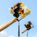 Graduation cap with floral decoration and tassel, black mortarboard for celebration. - Style 8