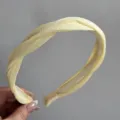 Chic yellow twisted satin headband for women, versatile hair hoop with comfortable grip. - Simple Twist Headband / Yellow