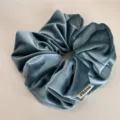 Velvet hair scrunchie detail view, soft blue high elastic hair tie for elegant daily styling. - Blue