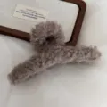 Detailed shot of large brown plush hair claw clip for women, fluffy winter hair accessory. - Khaki