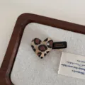 Close-up of cute leopard print heart hair clip with sparkling rhinestone and metal duckbill. - Light Heart Hair Claw Clip / Leopard Print