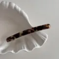 detail view of slim acetate hair clip with tortoise shell pattern elegant spring barrette - Tortoiseshell