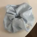 Detailed close-up of blue and white plaid fabric hair scrunchie showing cute texture and small tag. - Blue Fresh Scrunchie - Fine Plaid