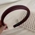 Detailed view of elegant dark red wide padded headband, soft texture with handmade label. - Wide Border Headband / Burgundy