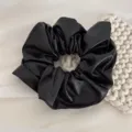 Black PU leather hair scrunchie detail view, soft puffy texture for daily ponytail styling. - Scrunchie / Black