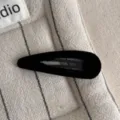 Close-up detail of a black velvet snap hair clip featuring soft texture and simple stylish design. - Teardrop Clip / Black