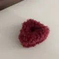 Detailed view of a cute dark red fluffy hair claw clip, soft plush styling accessory. - Red