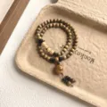 Detailed close-up of a vintage wooden bead double-layer bracelet, literary retro design. - Bead Pendant Style