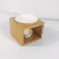 Detail shot of wooden aromatherapy oil burner with ceramic dish and candle for home decor. - Square Style