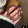 Double-strand garnet gemstone bracelet featuring delicate colorful beads and metal charm detail. - Flower Pendant