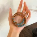Close-up detail of the vintage Chinese style double-wrap sandalwood and blue stone bead bracelet. - Blue Quartzite Jade Style