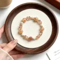 Close-up detail of new Chinese style retro crystal pearl beaded stretch bracelet, elegant accessory. - Citrine Quartz With Faceted Rondelle Beads