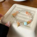 Sweet macaron orange agate and crystal bracelet with lovely fish charm detail view. - Small Koi Fish Style