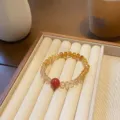 Elegant gradient crystal wheel bead bracelet, luxury design retro style jewelry detail. - Red Agate