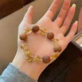 Chinese style sandalwood citrine crystal beaded bracelet with gold lock charm detail view. - Barbie Sandalwood Bead Style (1) / Wood Color