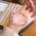 Close-up detail of a sweet translucent candy core agate bead bracelet, elegant design. - Spaced Artificial White Crystal Style