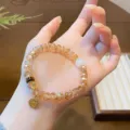 Detailed view of the new Chinese style gradient crystal faceted bead bracelet with chic charms. - Round Pendant Style