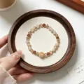 Detailed close-up shot of a vintage Chinese style yellow crystal beaded stretch bracelet. - Citrine Quartz With Maillard Faceted Crystal