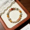 Close-up detail of a stunning multi-color crystal and pearl beaded bracelet, elegant and chic. - Running Ring Style