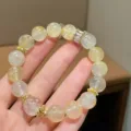 Detailed close-up shot of the natural yellow quartz bracelet with exquisite gold-toned spacers. - Large Bead Clear Quartz Style