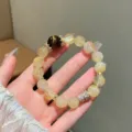 Detailed close-up of the natural yellow quartz and tiger eye gemstone beaded bracelet with rhinestones. - Large Bead Yellow Tiger's Eye Style