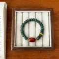 Detailed view of retro style jadeite abacus bead bracelet with red carnelian focal. - Dragon Vein Red Agate Style