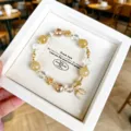Charming natural crystal beaded bracelet with exquisite golden leaf pendant, elegant detail view. - Optimized Citrine Style