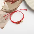 Red braided rope bracelet with bell and Chinese style charm for lucky New Year gift. - Full of Vitality