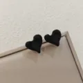 Detailed shot of black matte irregular heart earrings, minimalist design jewelry close-up. - Matte Three-Dimensional Heart Style (A24-164G) / Black
