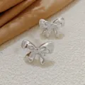 Detailed view of silver bow stud earrings, chic Korean style fashion jewelry for women daily wear. - Glossy Bowknot Style (A24-158R) / Silver