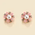 Exquisite detail of pearl and pink flower stud earrings featuring sparkling rhinestones. - Pink