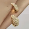Detailed close-up of modern irregular waterdrop hammered gold stud earrings with elegant textured finish. - Irregular Hammered Teardrop Style (A24-040P) / Gold