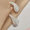 Detail shot of silver textured conch earrings, showing exquisite metallic luster and shape. - Three-Dimensional Hammered Conch Style (A24-067R) / Silver