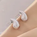 Detailed view of trendy ribbed teardrop stud earrings in silver finish, elegant jewelry piece. - 3D Rippled Teardrop Style (A24-109R)
